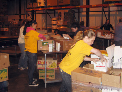 Seattle area VMs join volunteers from several local businesses and charitable organizations to pack food boxes destined for the hungry.