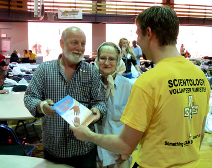 A Volunteer Minister assists a couple at a shelters.