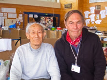 Peter Dunn (right) with a man he helped in a school gymnasium converted to a shelter for those displaced by the March 2011 earthquake